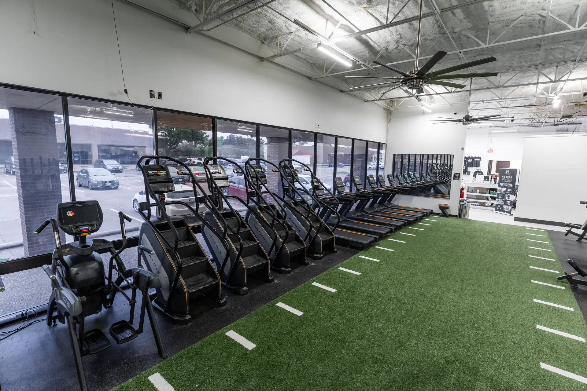 Cardio equipment and turf at Hidden Gym North Dallas